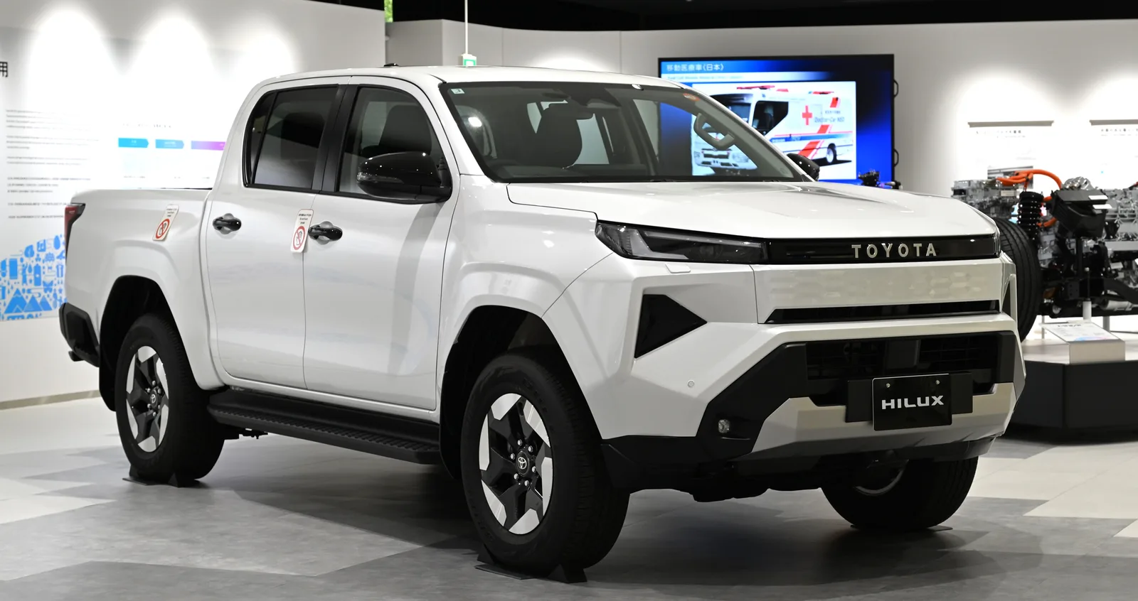 Toyota Hilux 2026 nouvelle génération vue trois quarts avant showroom pick-up blanc