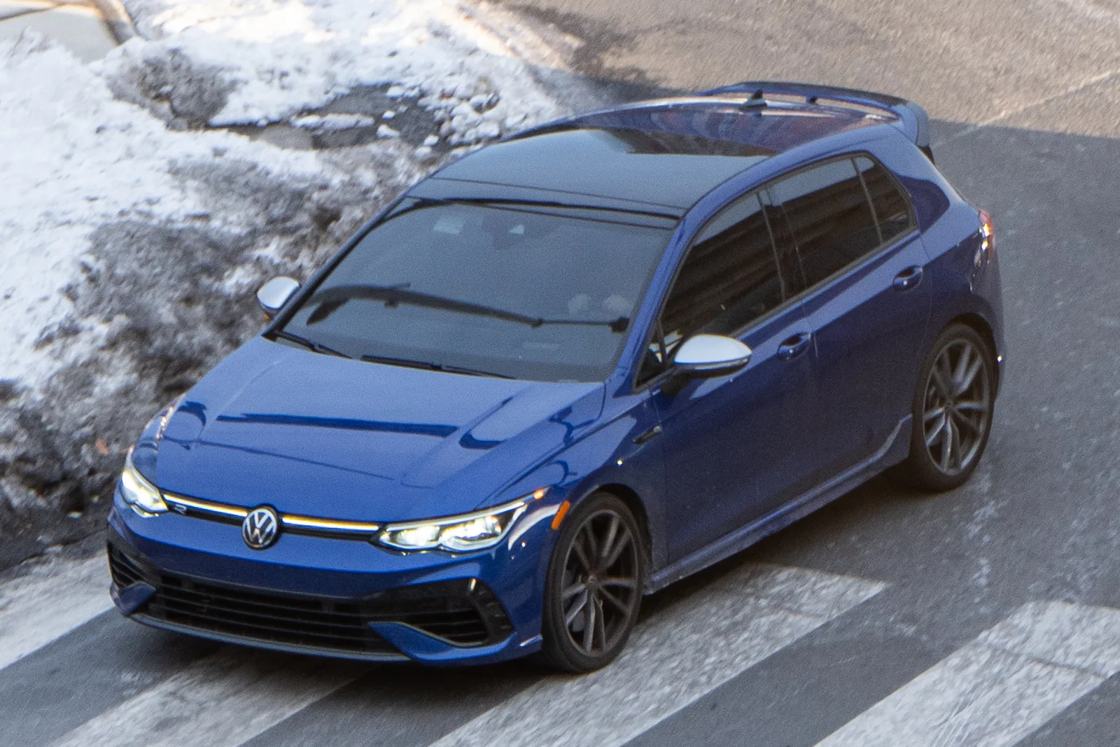 Volkswagen Golf R 2026 bleue vue plongeante avant sur route enneigée