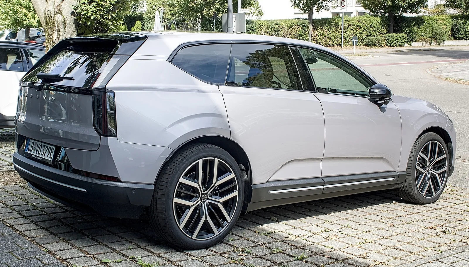 Volvo EX60 grise vue de l'arrière et de profil, avec ses feux arrière verticaux